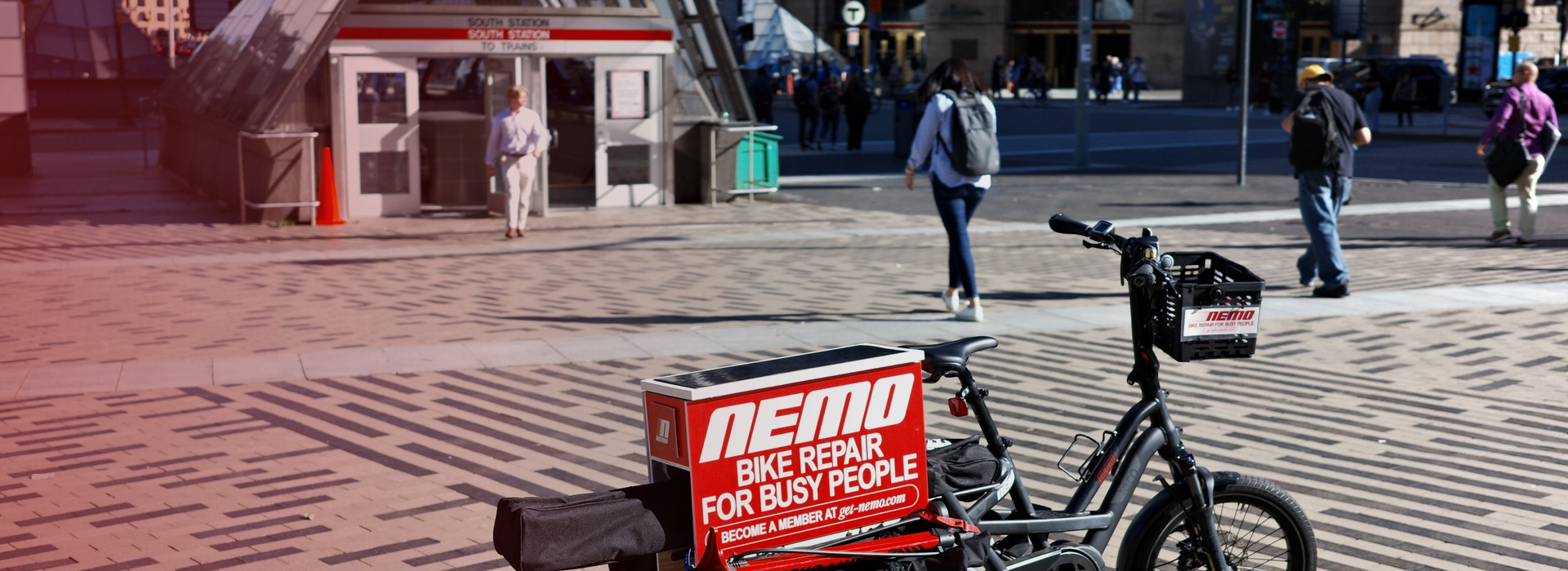 NEMO mechanic on cargo bike arriving at a workplace